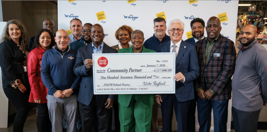 A group of people holding a large check to support food donation efforts with MUST Ministries and their neighborhood pantry.